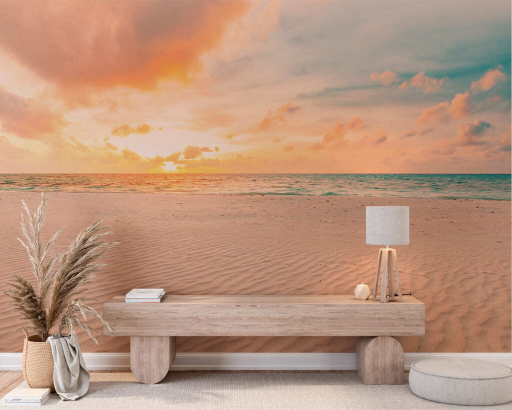 A sandy beach with waves and a sunset