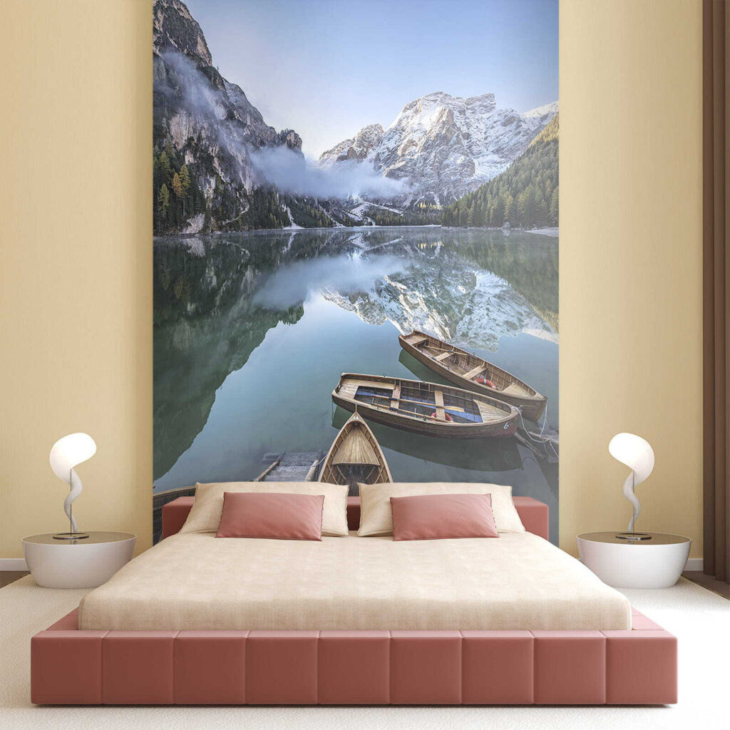 Boats on a lake with mountains in the background