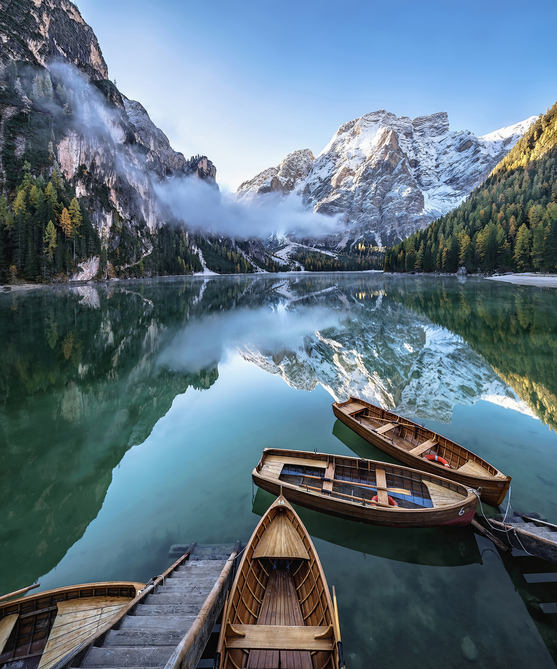Boats on a lake with mountains in the background