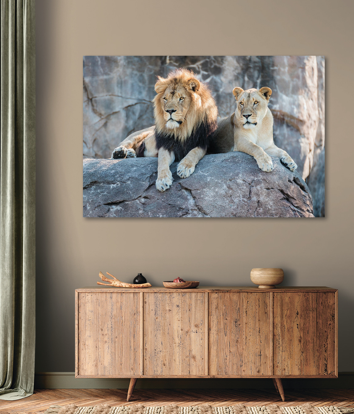 A couple of lions lying on a rock