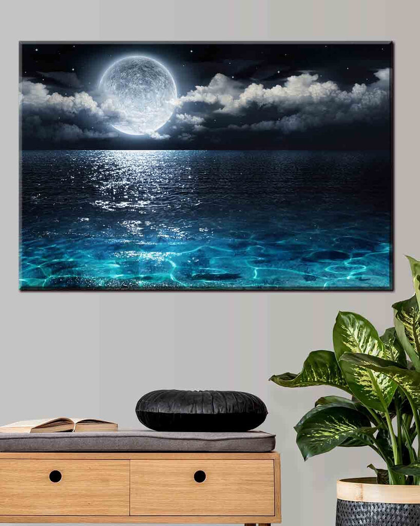 A moon over water at night