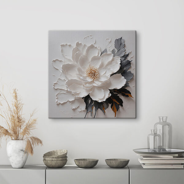 A white flower with black and grey leaves