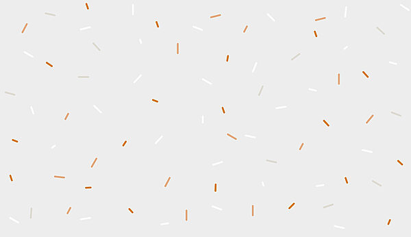 Weiße und orangefarbene Streusel auf grauem Hintergrund Weiße und orangefarbene Streusel auf grauem Hintergrund