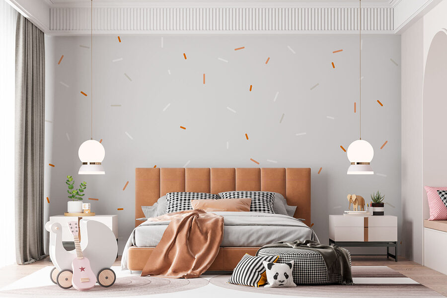 Weiße und orangefarbene Streusel auf grauem Hintergrund