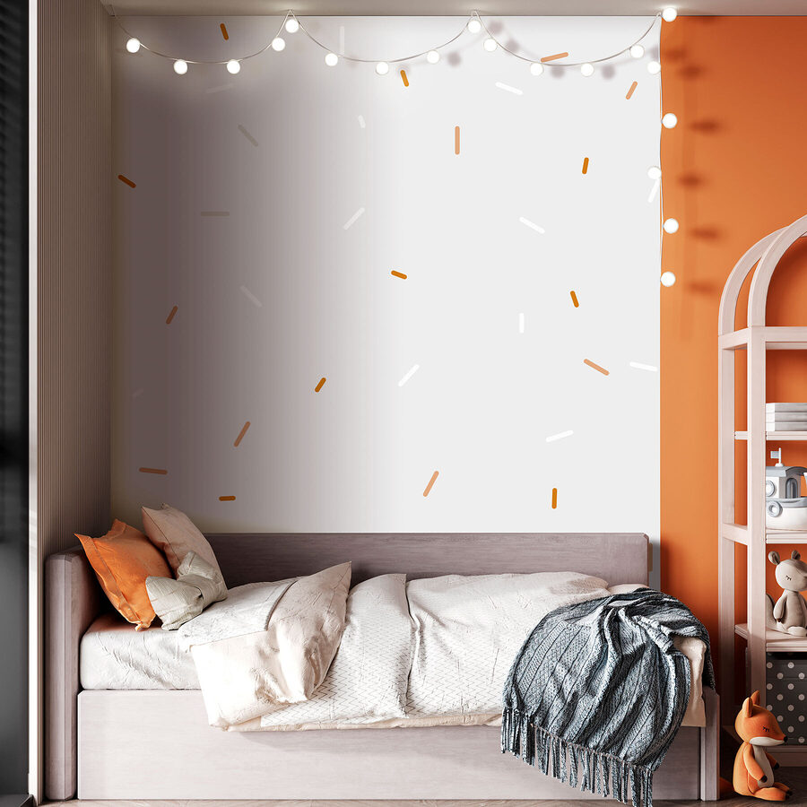 Weiße und orangefarbene Streusel auf grauem Hintergrund