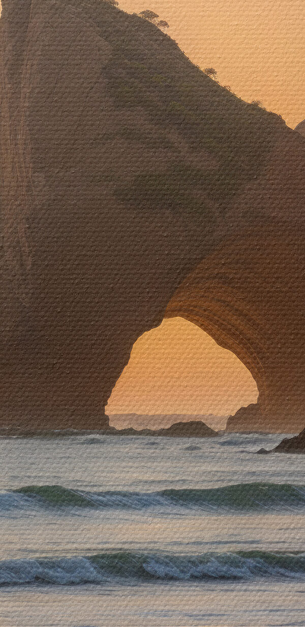 Sunset over a beach with rocks and water