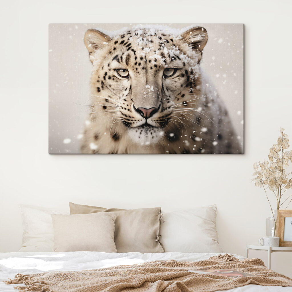 Snow leopard with snow on its head