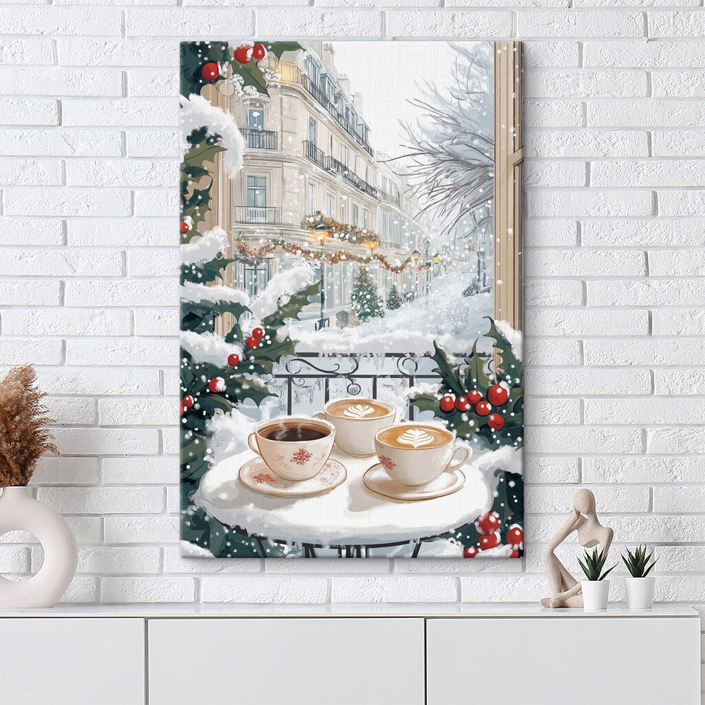 Couple of cups of coffee on a balcony with snow and buildings