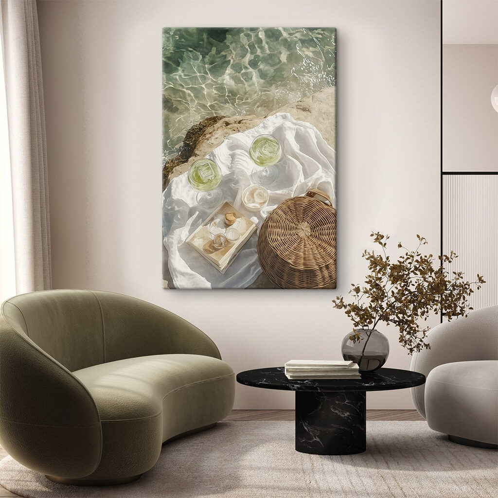 Picnic basket and glasses of wine on a rock by water