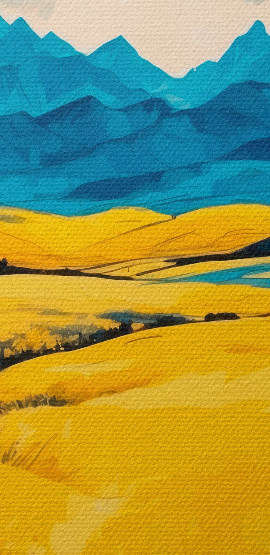 Gelbes Feld mit Bergen im Hintergrund