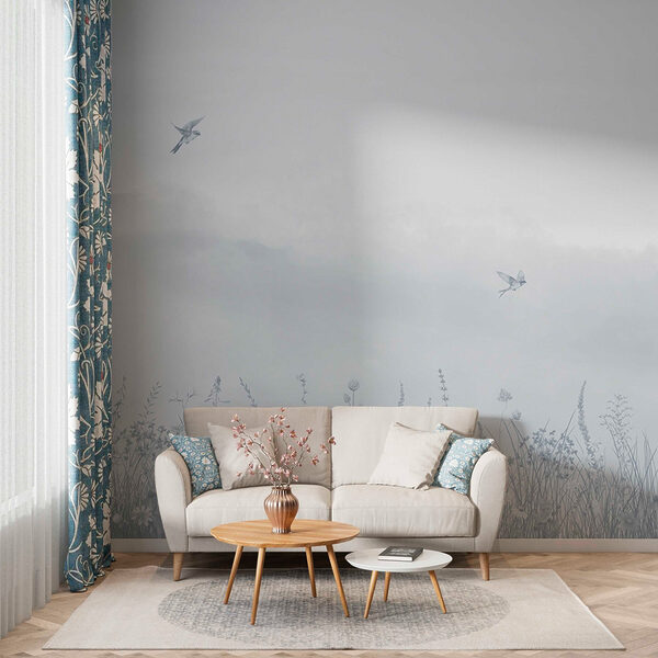 Bird flying over a field of flowers