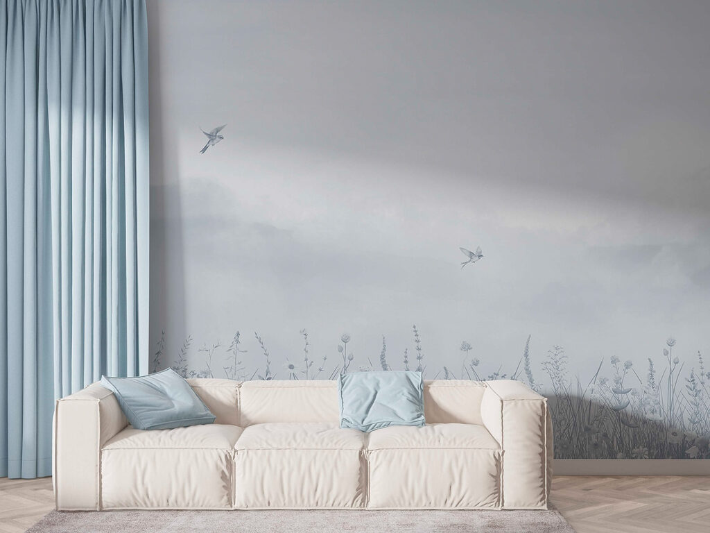 Bird flying over a field of flowers