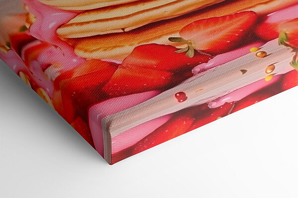 Stack of pancakes with pink frosting and strawberries