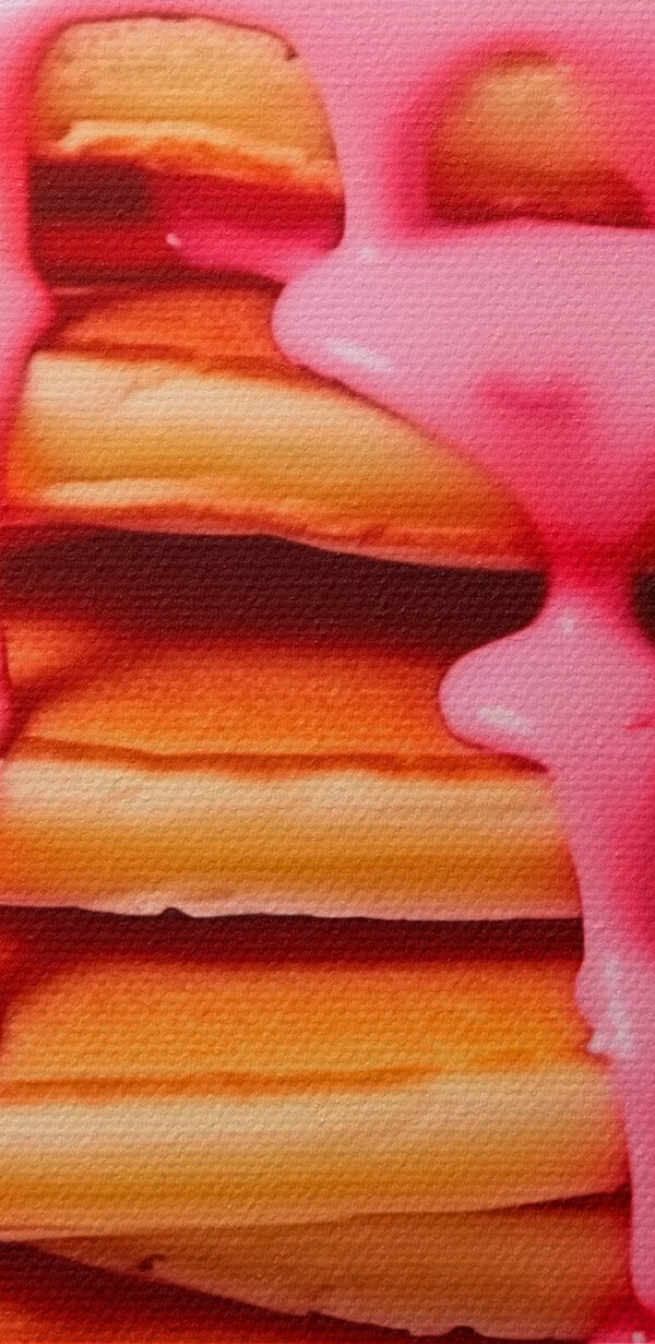 Stack of pancakes with pink frosting and strawberries