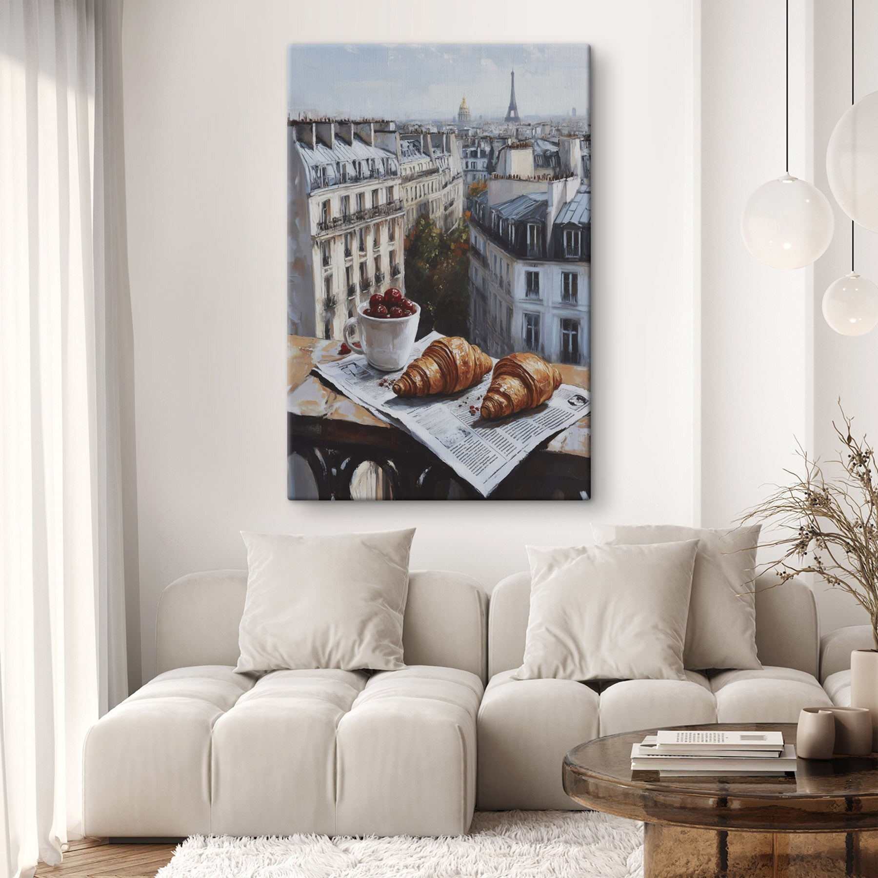 Cup of coffee and croissants on a table with buildings in the background