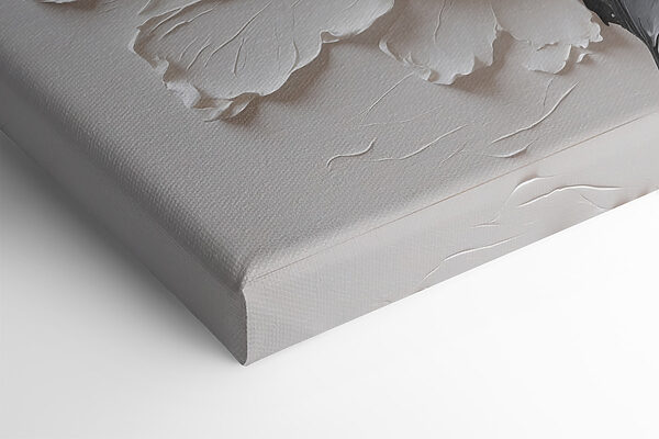 A white flower with black and grey leaves