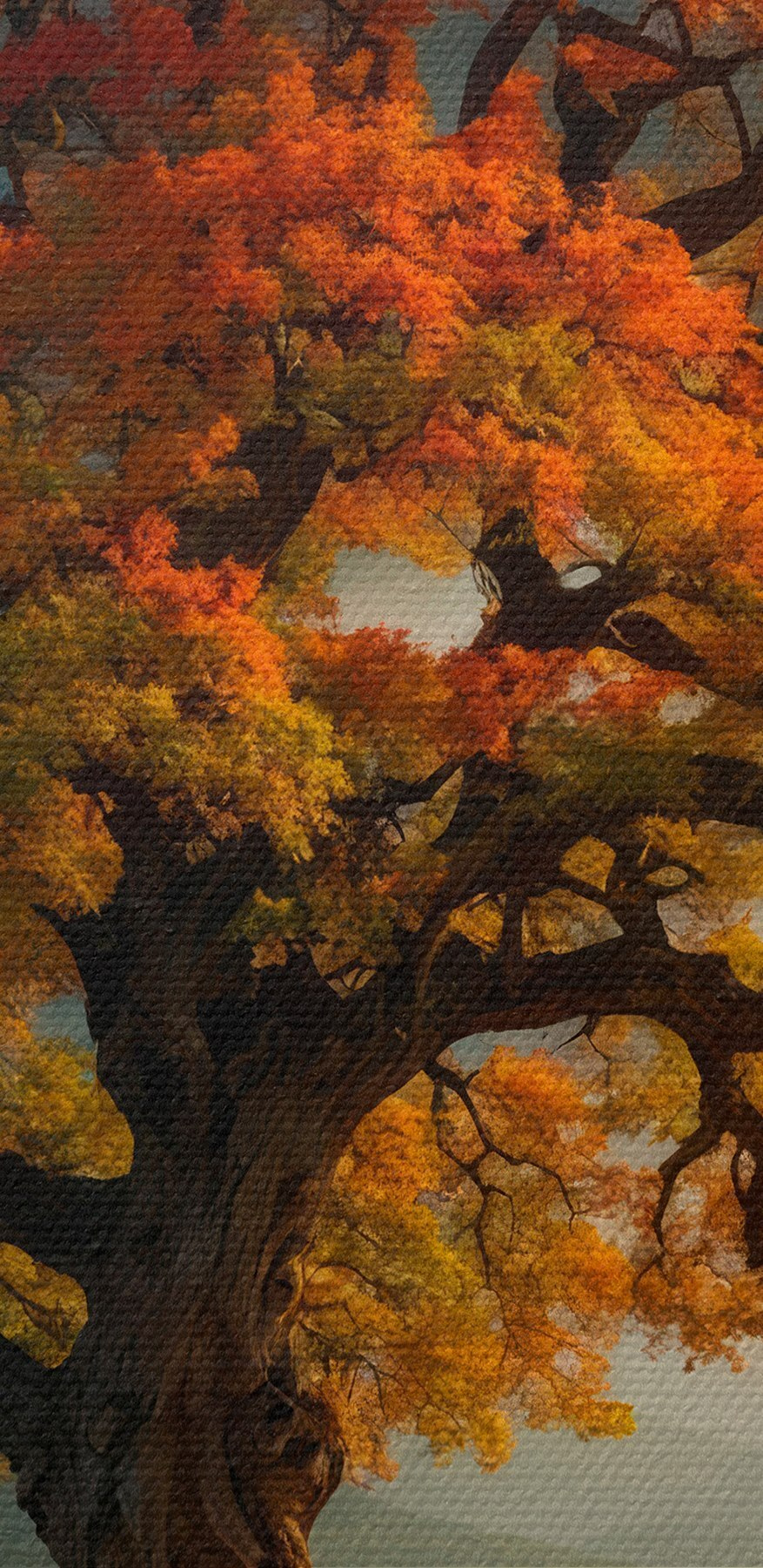 Baum mit orangefarbenen und gelben Blättern auf einem Hügel