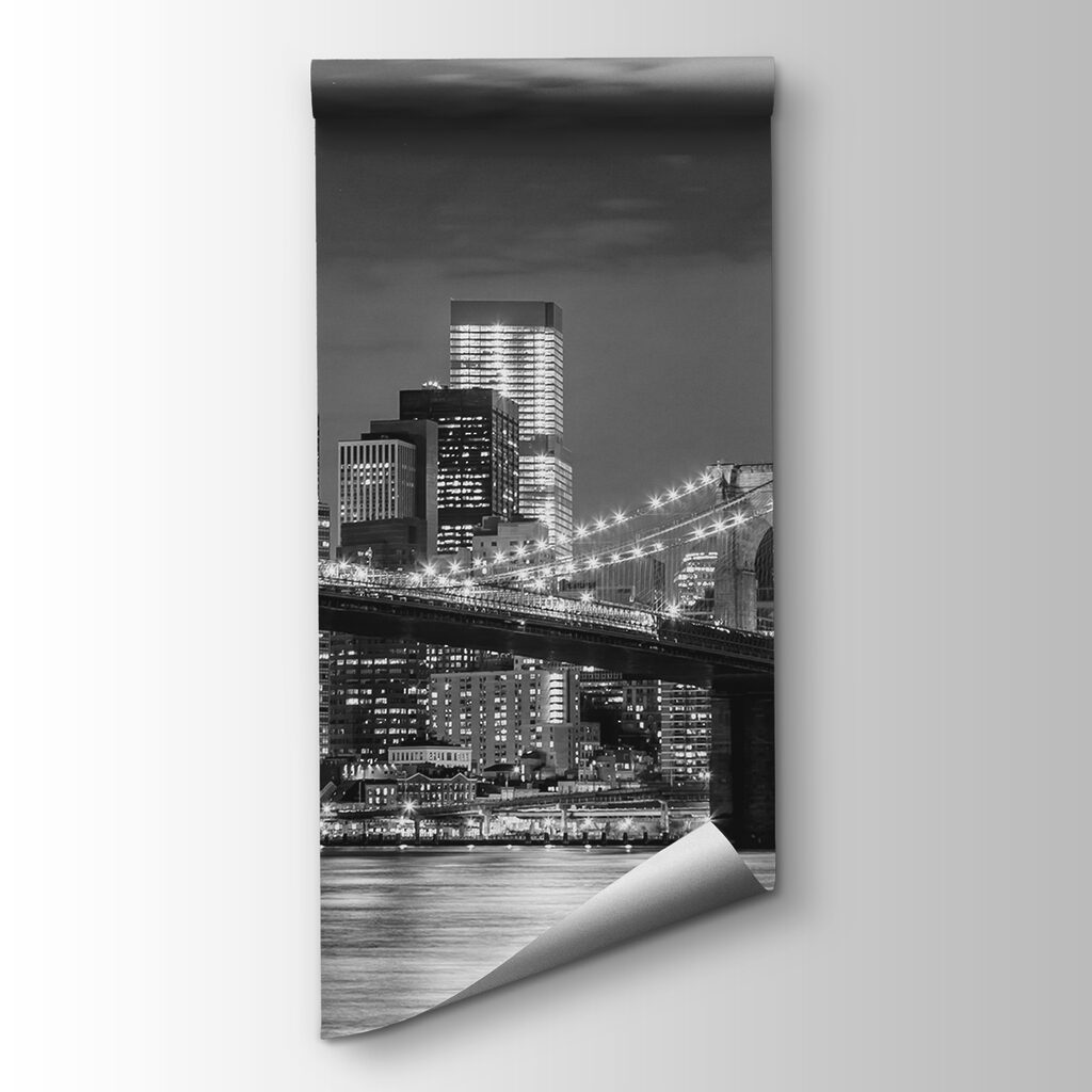 Bridge over water with city skyline at night