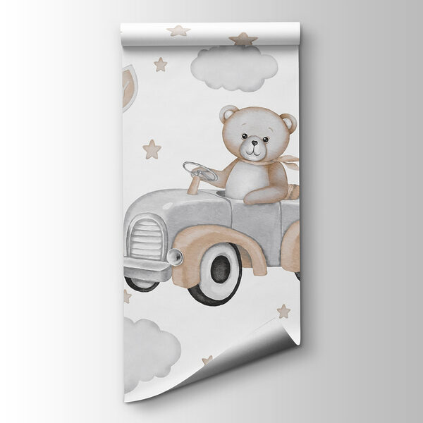 Teddy bear driving a car with balloons