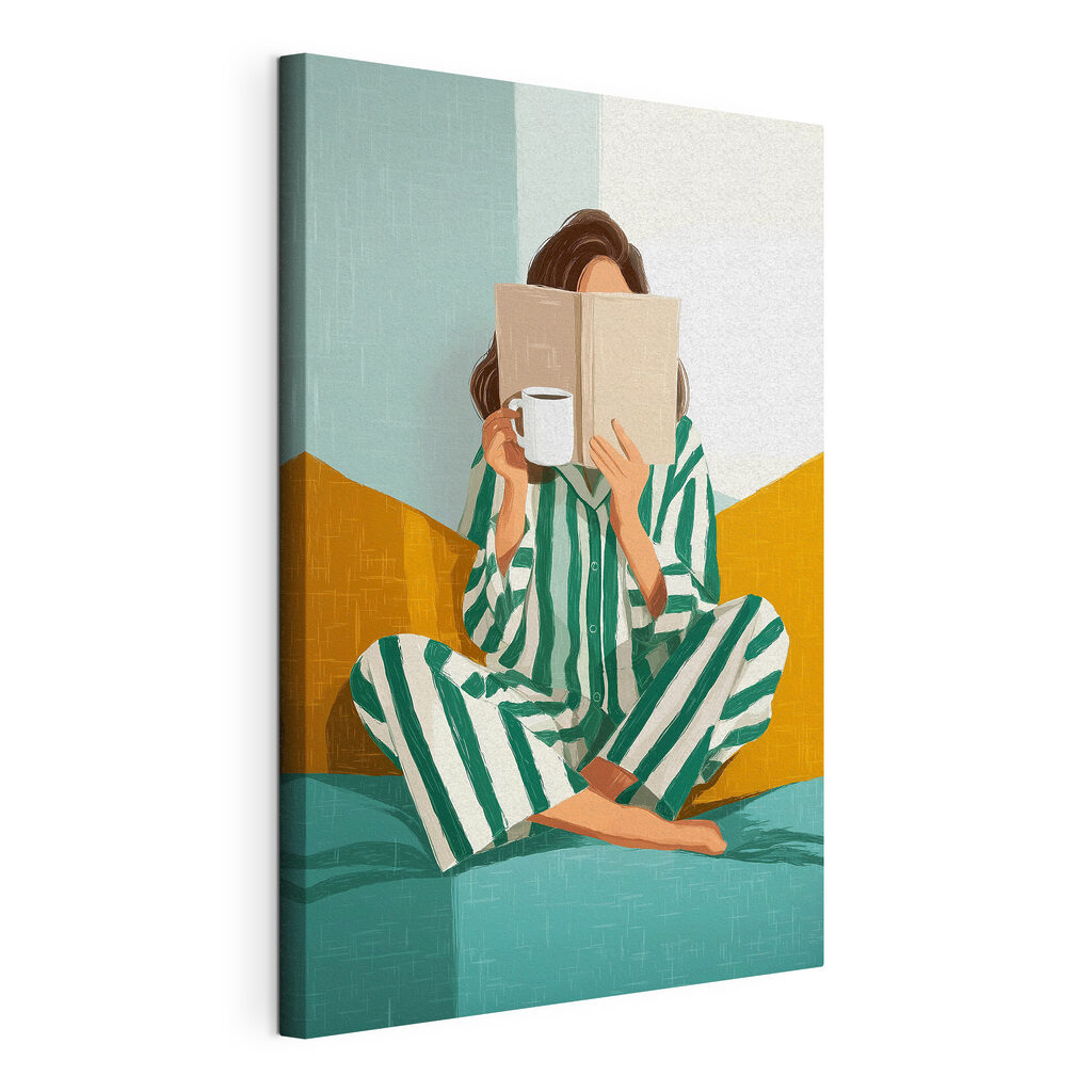 Woman sitting on a bed with a book and a mug