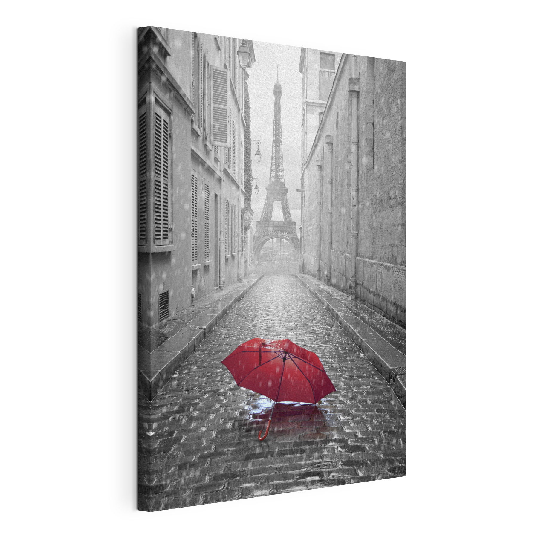 A red umbrella in a street with a tower in the background A red umbrella in a street with a tower in the background